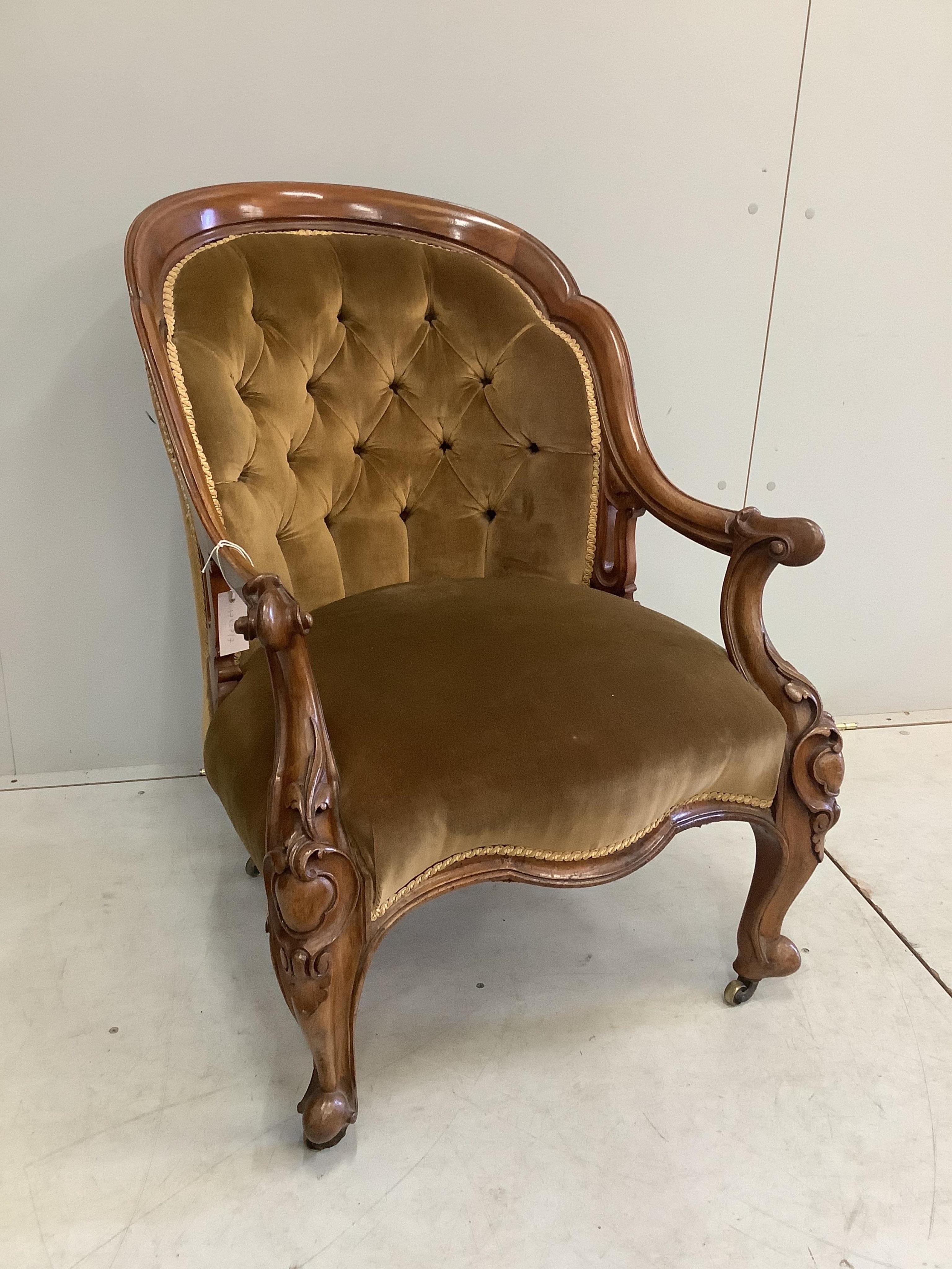 A late Victorian carved walnut spoonback upholstered open armchair, width 68cm, depth 64cm, height 92cm. Condition - good